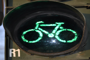 Grüne Ampel mit Fahrradsymbol, das an einer Wand leuchtet.