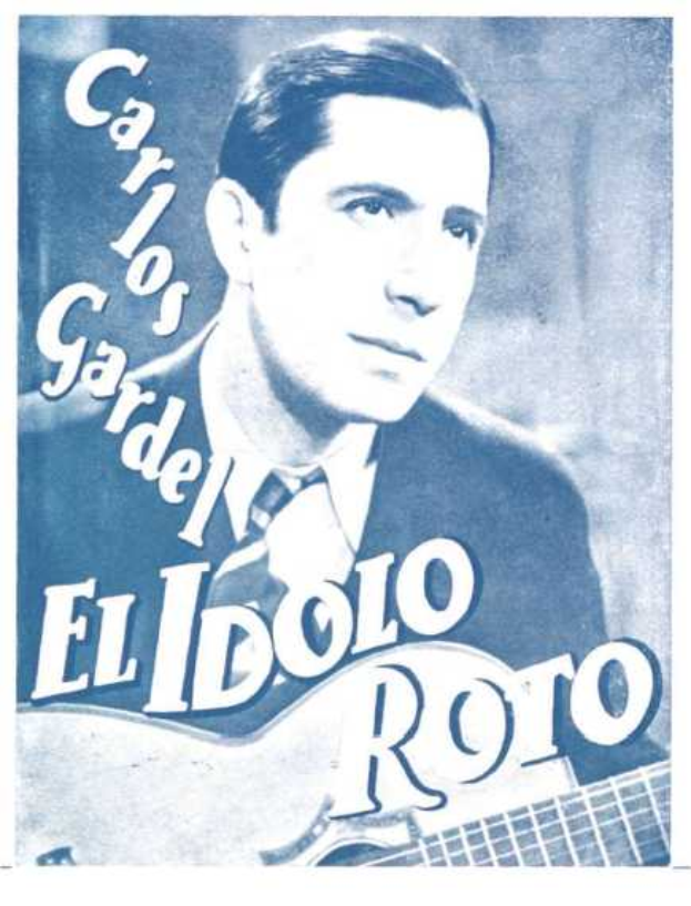 Plakat von El Idolo Roro, einem spanischen Singer-Songwriter, der eine Gitarre hält, ein weißes Hemd und einen schwarzen Anzug trägt, mit zurückgekämmtem Haar und einem ernsten Gesichtsausdruck, vor einem hellblauen Hintergrund mit fetter schwarzer Schrift.